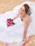 Beautiful bride posed in sitting position on the dance floor