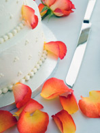 Beautiful cake with orange rose peddals scattered about